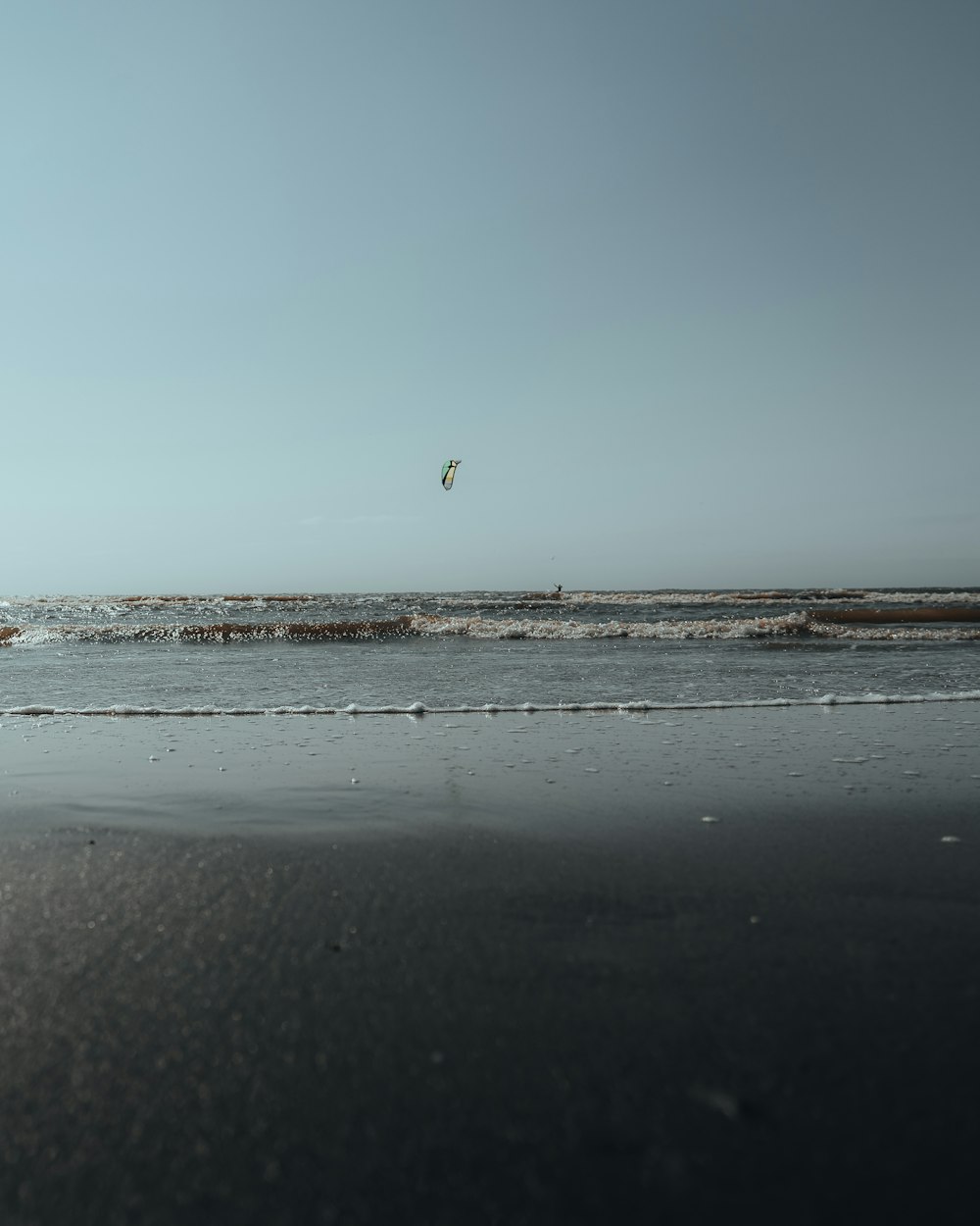 a person is flying a kite on the beach