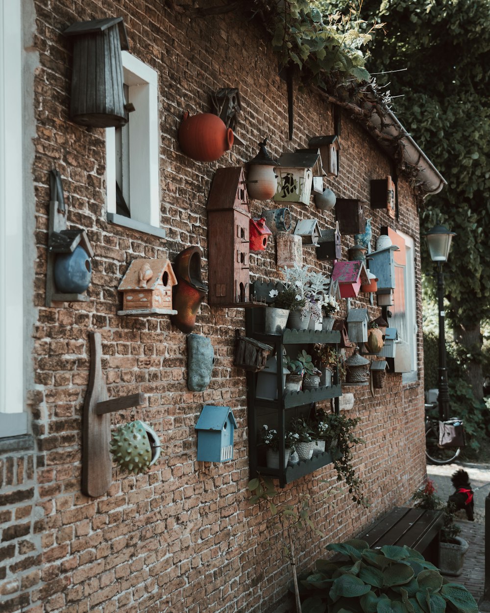 a brick wall with a bunch of bird houses on it