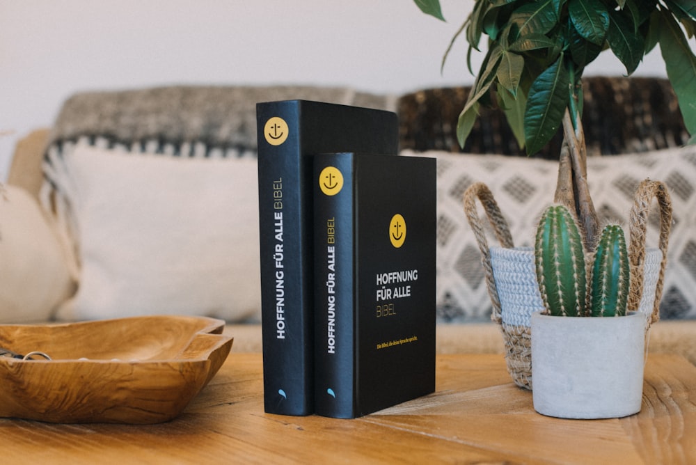 a couple of books sitting on top of a wooden table