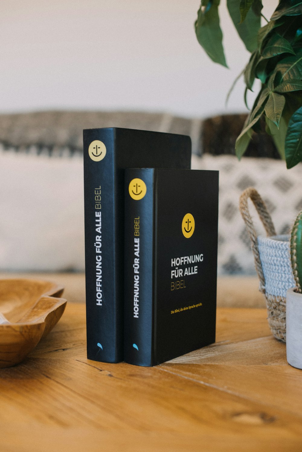 a couple of books sitting on top of a wooden table