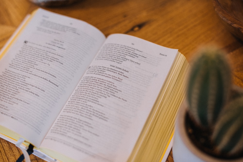 an open book sitting on top of a wooden table