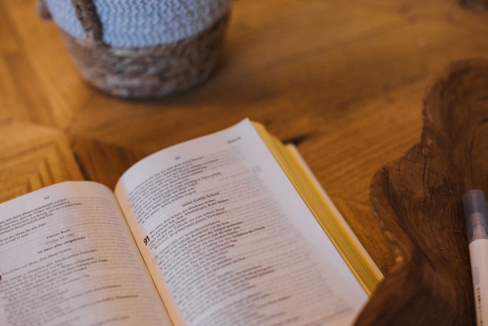 an open book sitting on top of a wooden table