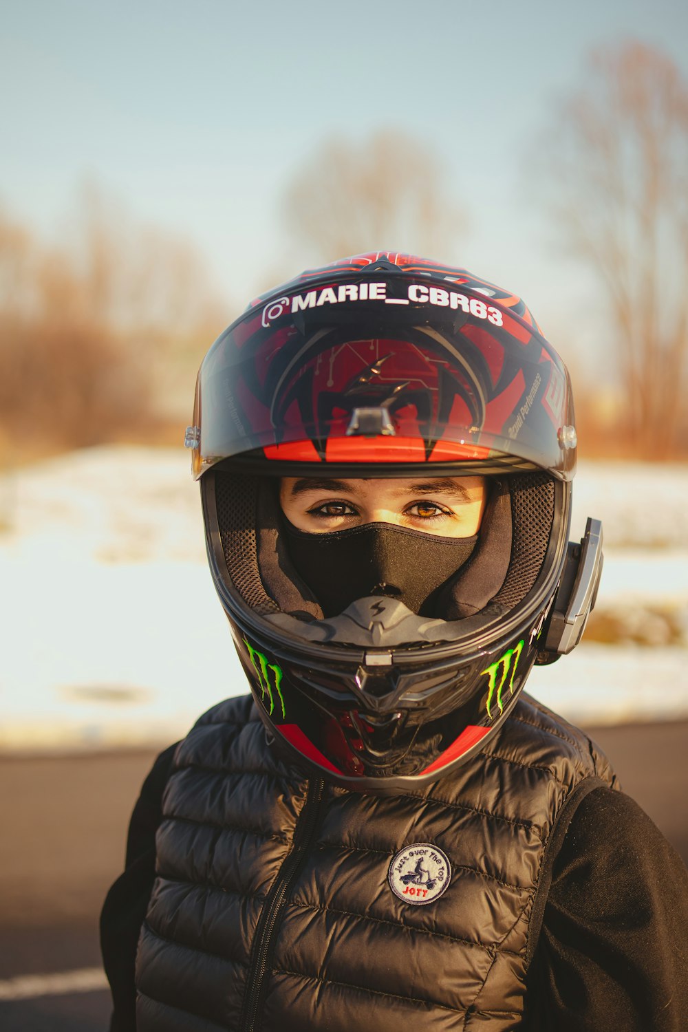 a young child wearing a helmet and jacket