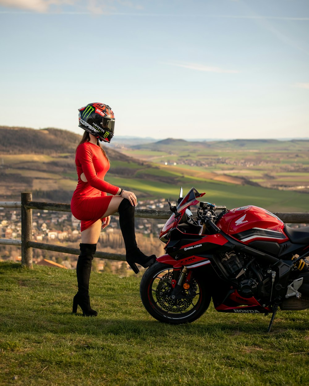 a woman in a red dress sitting on a motorcycle