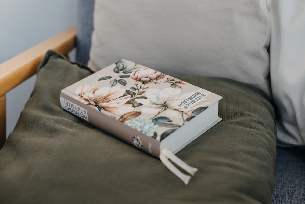 a book sitting on top of a green chair