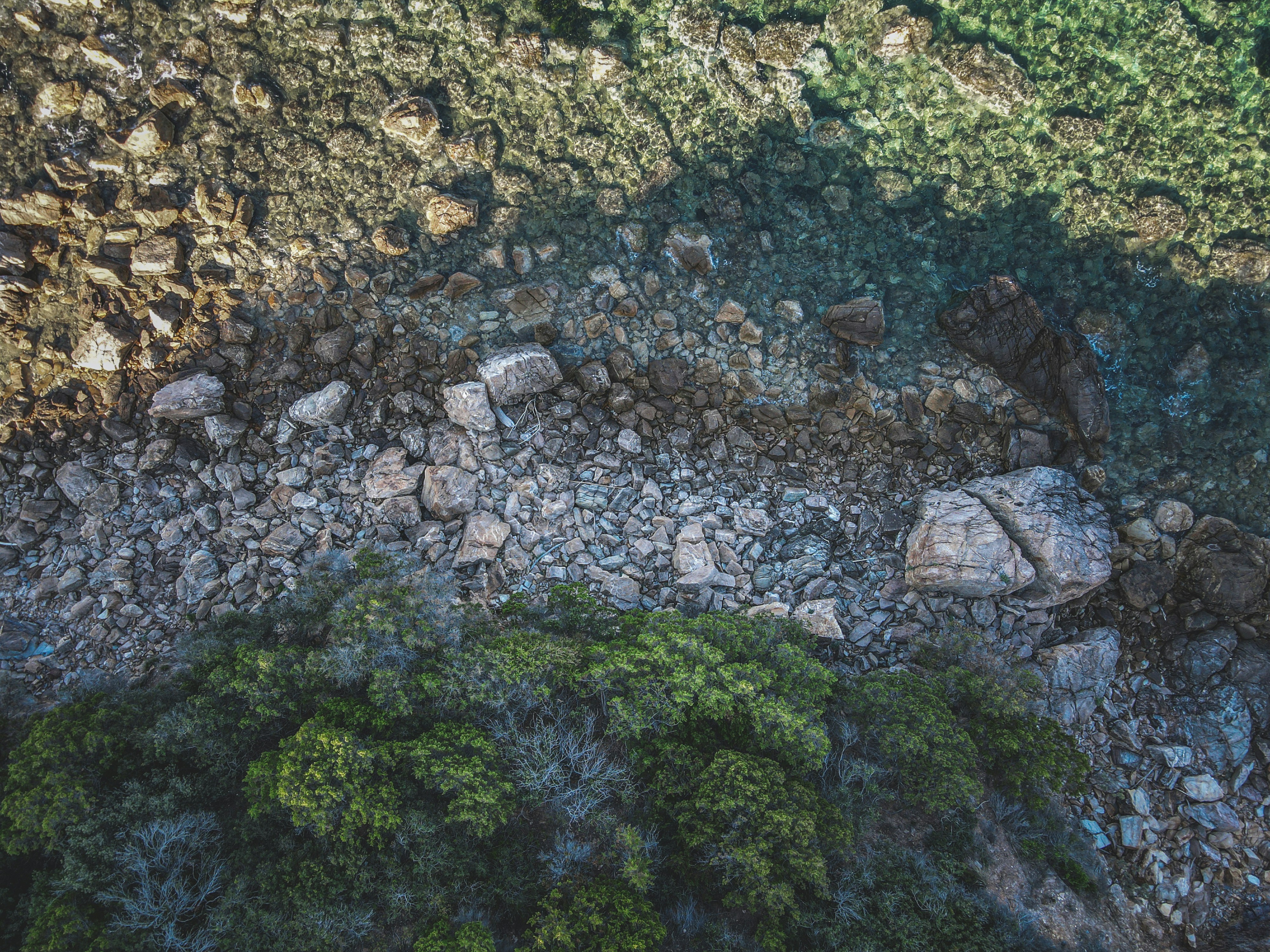 an aerial view of rocks and grass