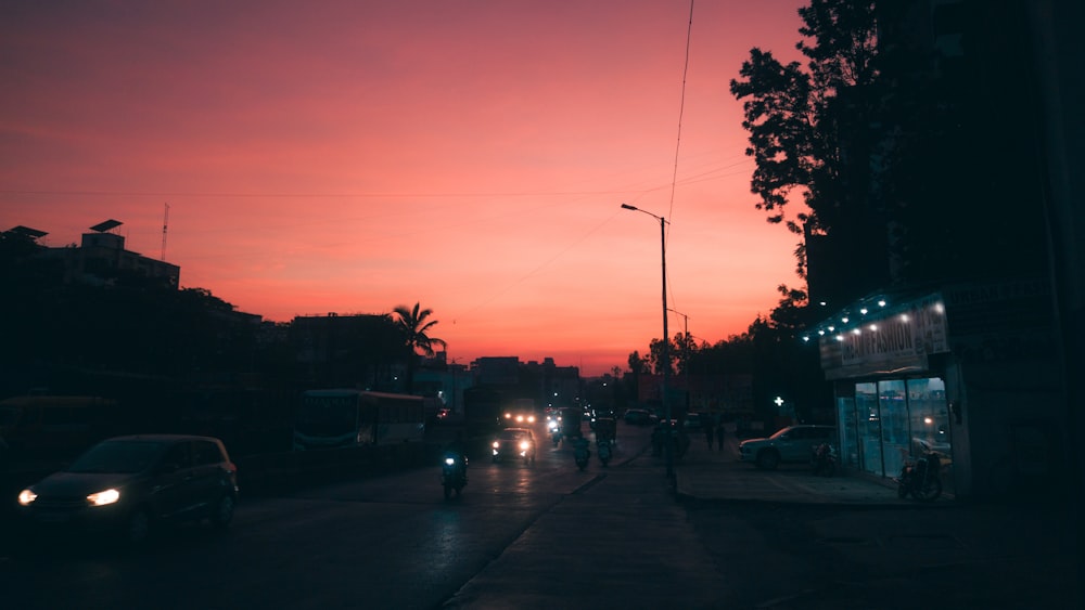 a city street at night with cars and people