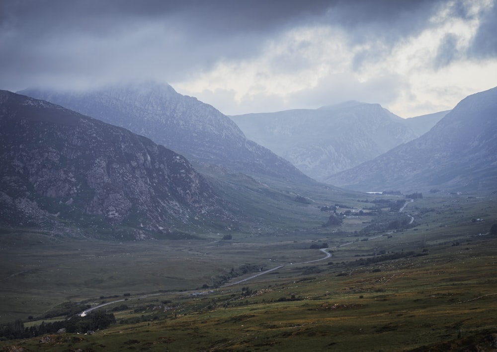 a view of a valley with mountains in the background