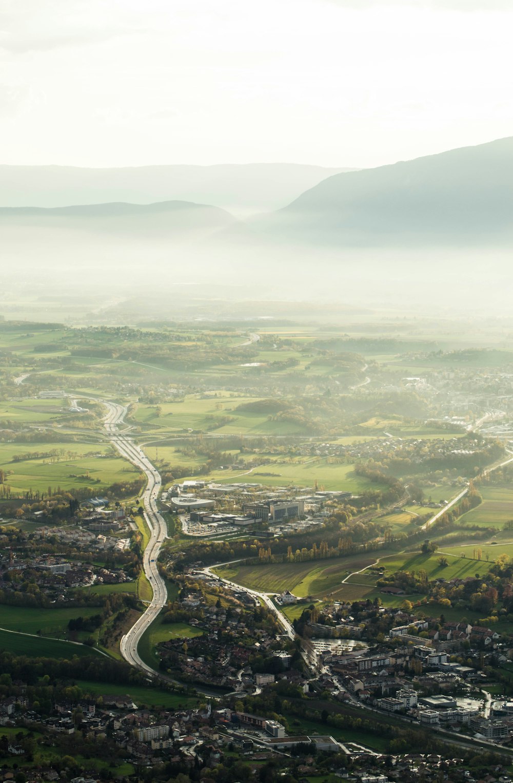 an aerial view of a city and a winding road