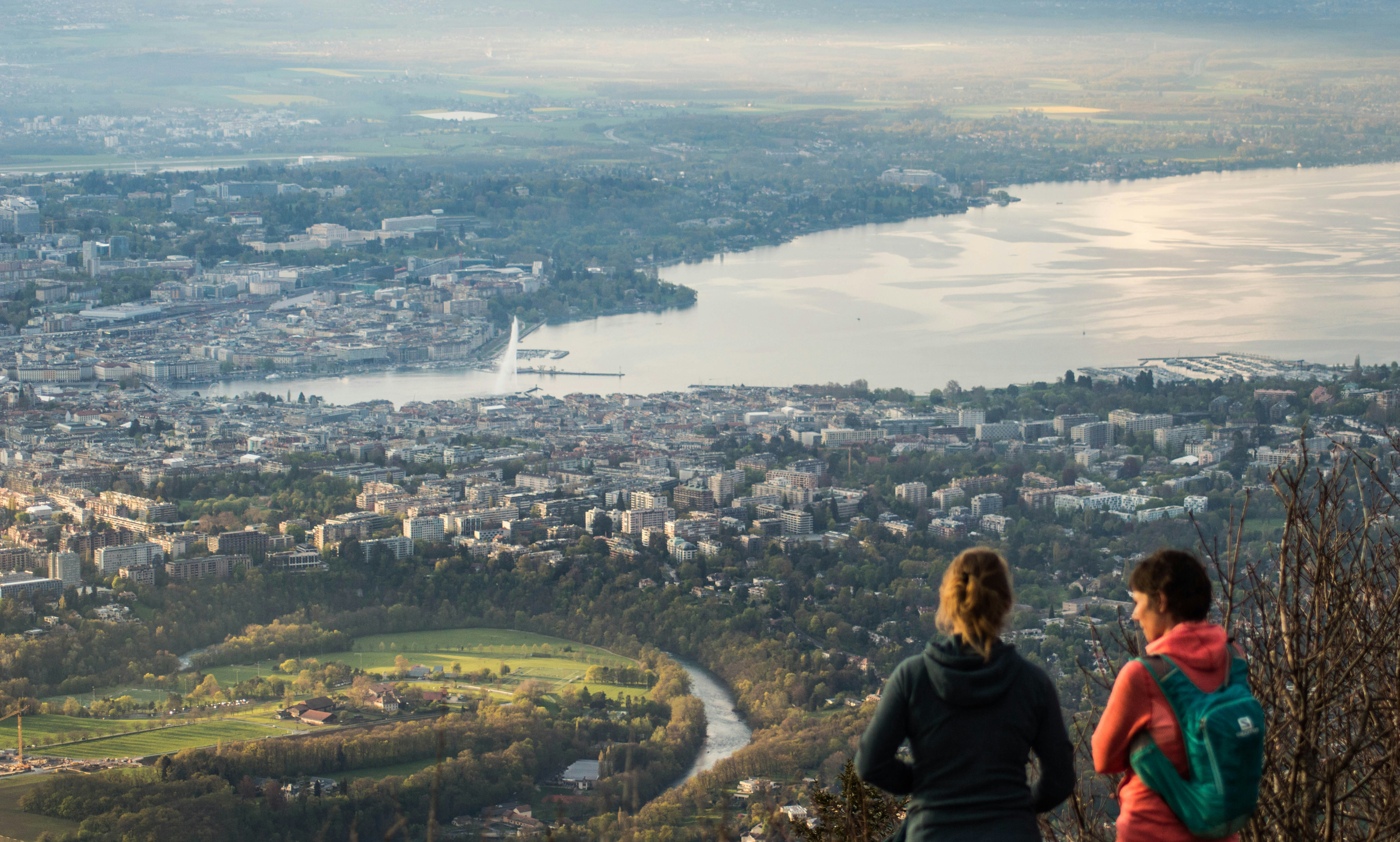 a couple of people standing on top of a hill