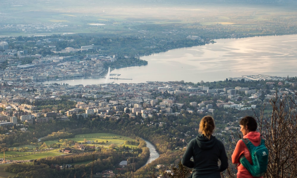 a couple of people standing on top of a hill