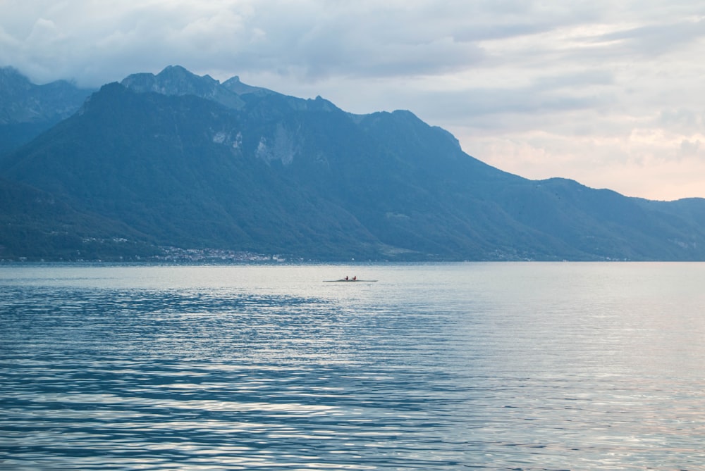 a lone boat in the middle of a large body of water