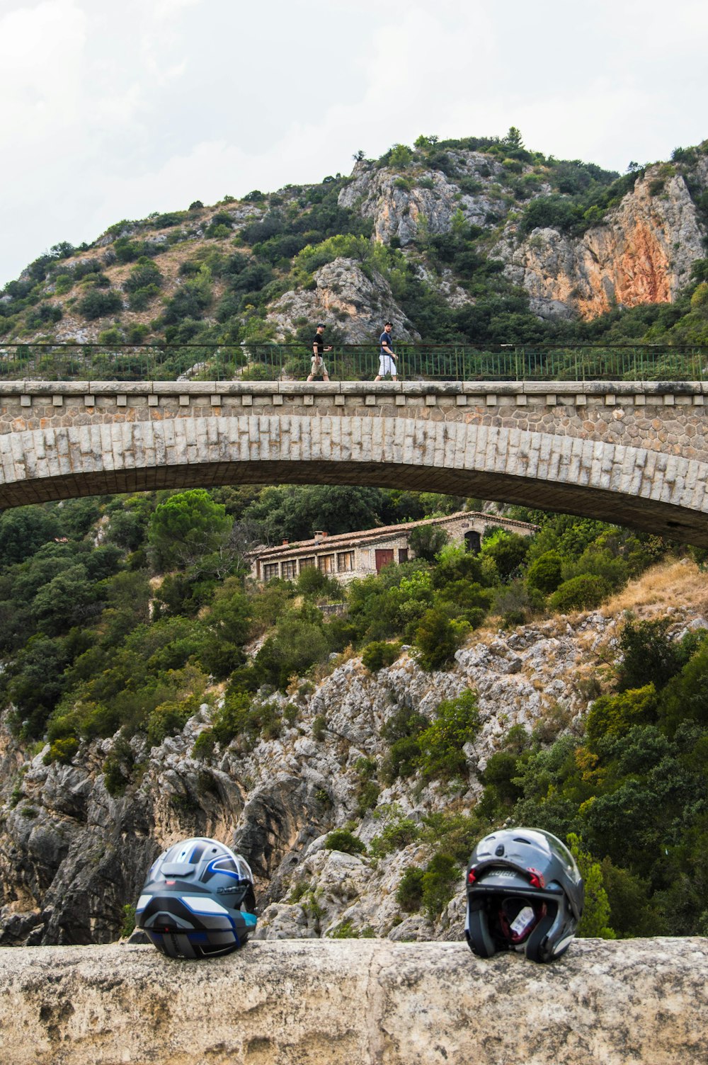 a couple of helmets sitting on top of a bridge