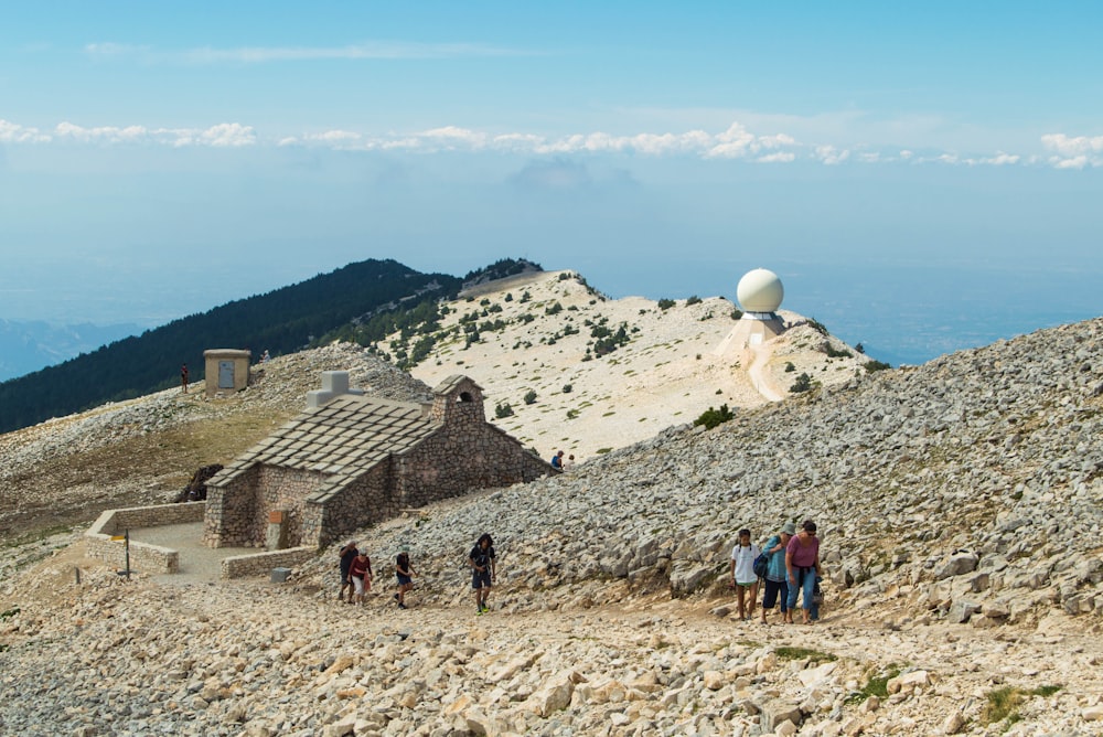 a group of people standing on top of a rocky hill