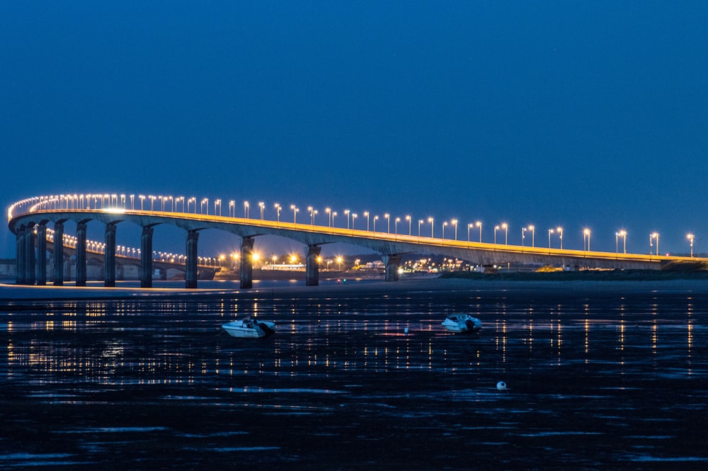 a large bridge over a body of water at night