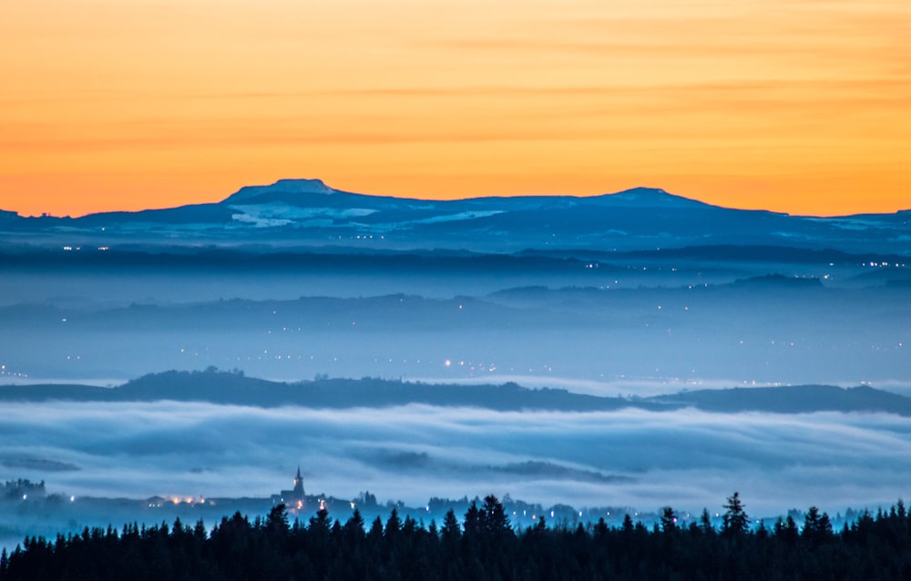 a view of a mountain range covered in fog