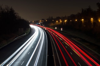 a long exposure photo of a highway at night