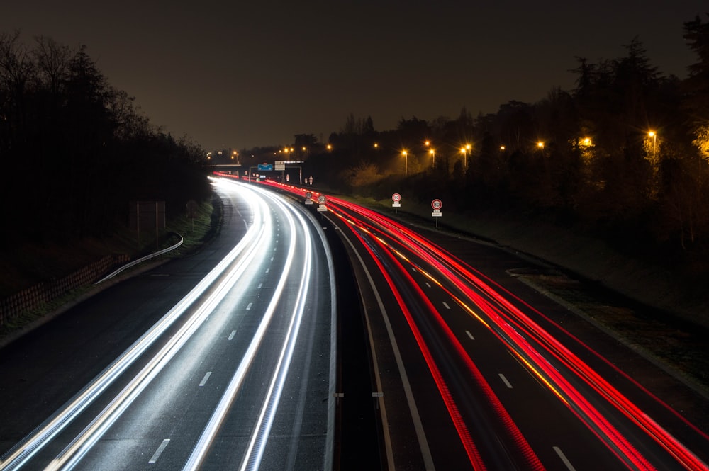 a long exposure photo of a highway at night