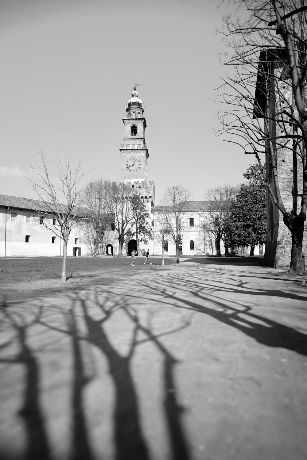 a black and white photo of a building with a clock tower