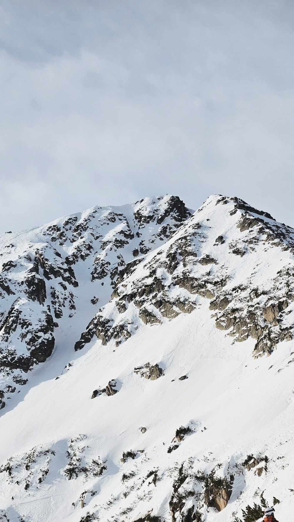 a man riding skis down the side of a snow covered mountain