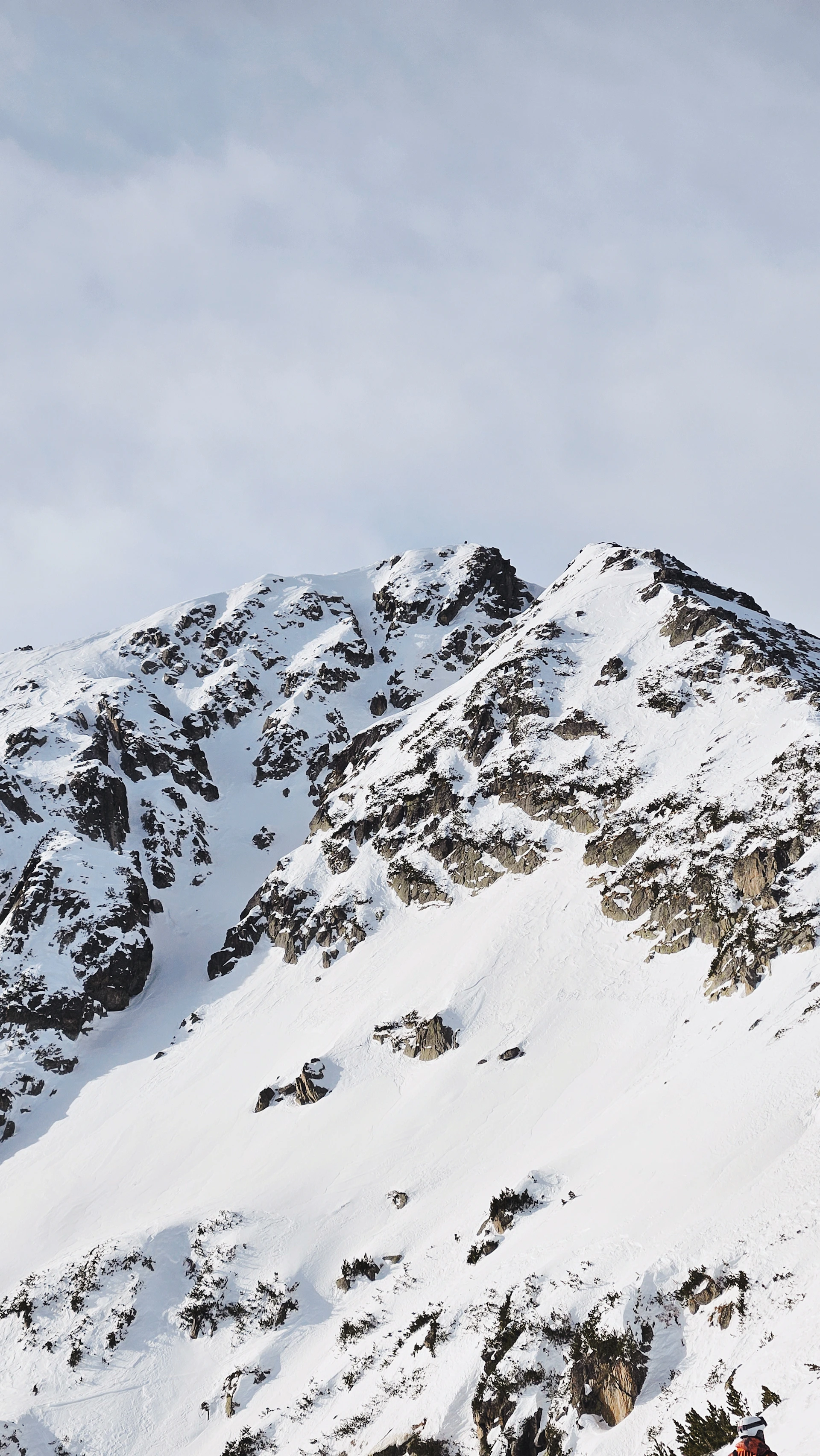 a man riding skis down the side of a snow covered mountain