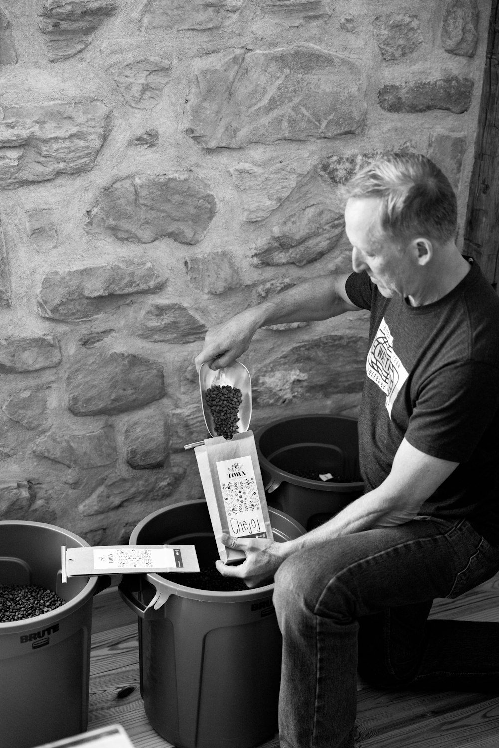 a man sitting on a bench next to two buckets