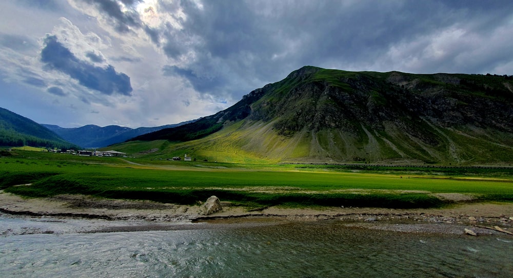 a river running through a lush green valley