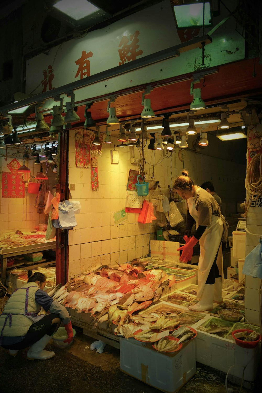 a couple of people standing in front of a fish market