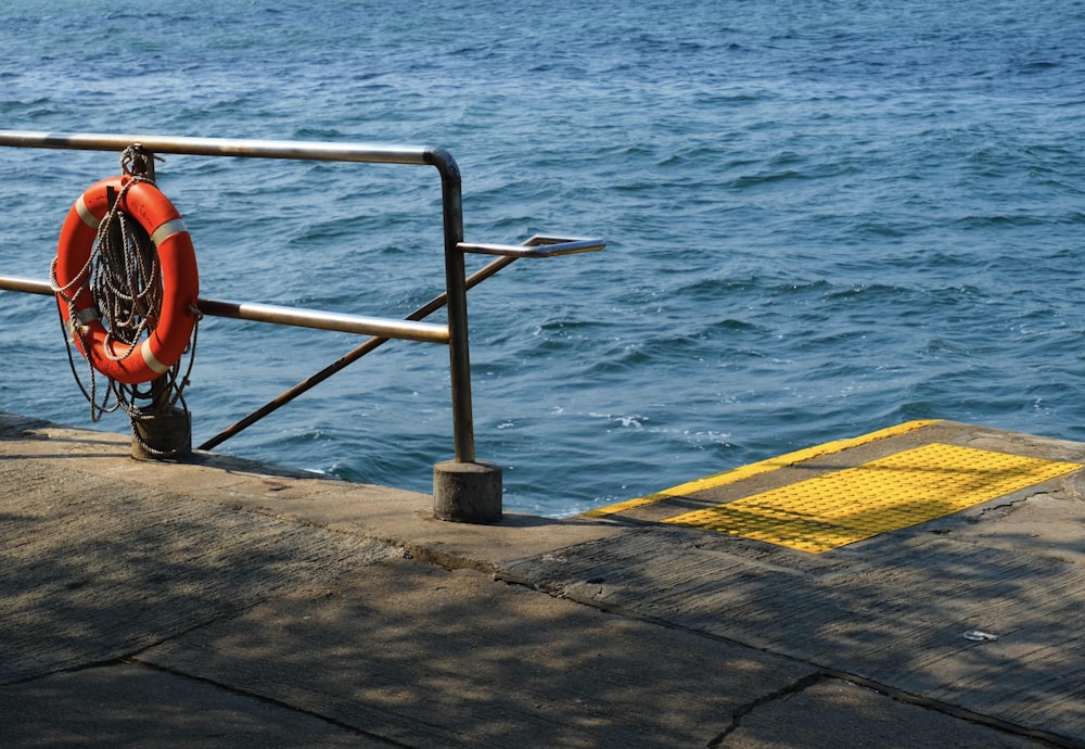 a life preserver on the edge of a pier