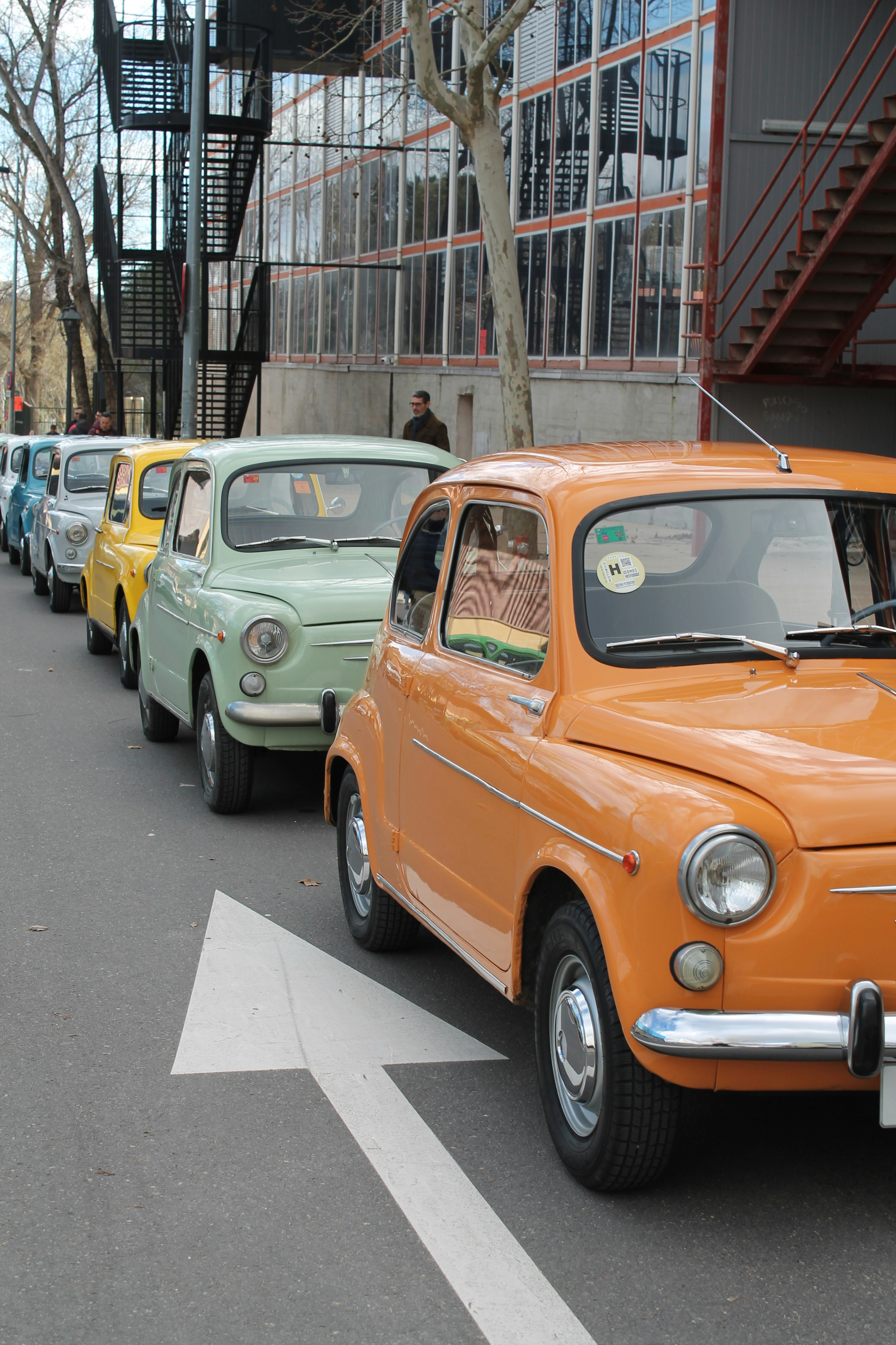a row of cars parked on the side of the road