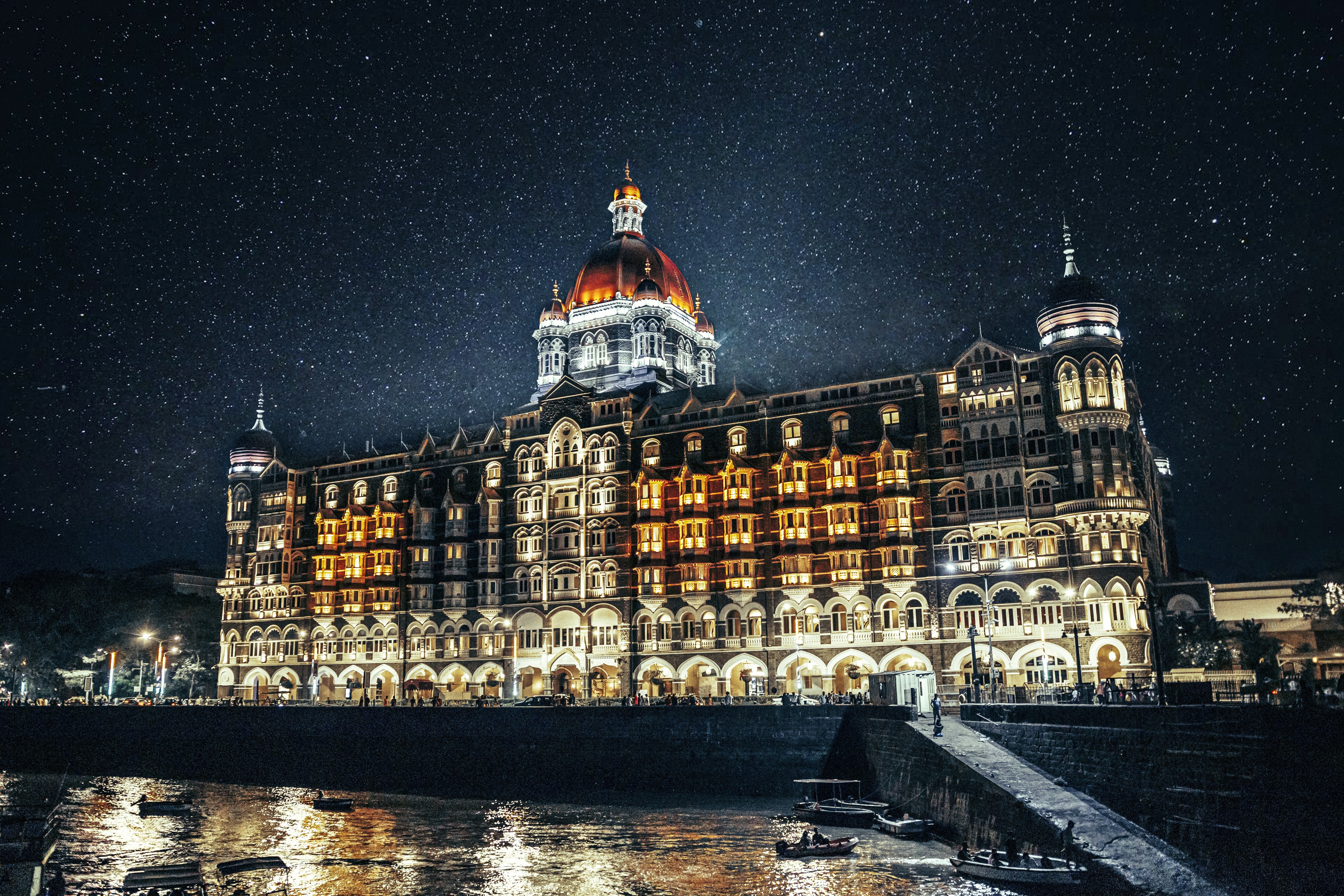 a large building lit up at night on the water