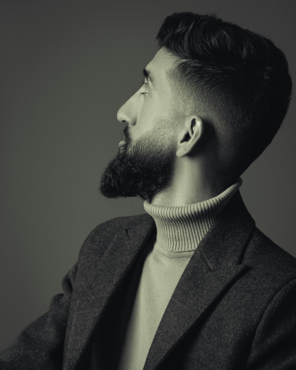 a black and white photo of a man with a beard