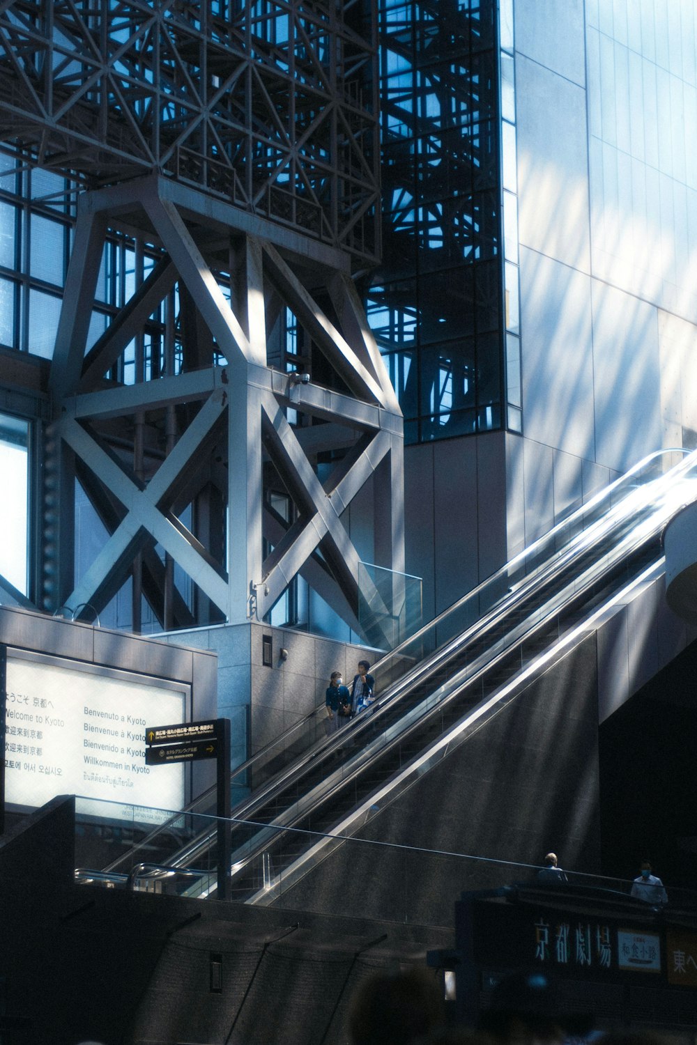 an escalator in front of a tall building