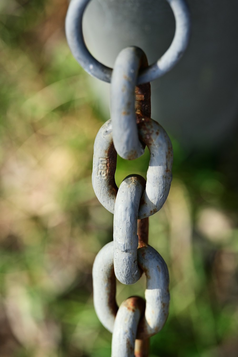 a close up of a chain hanging from a pole