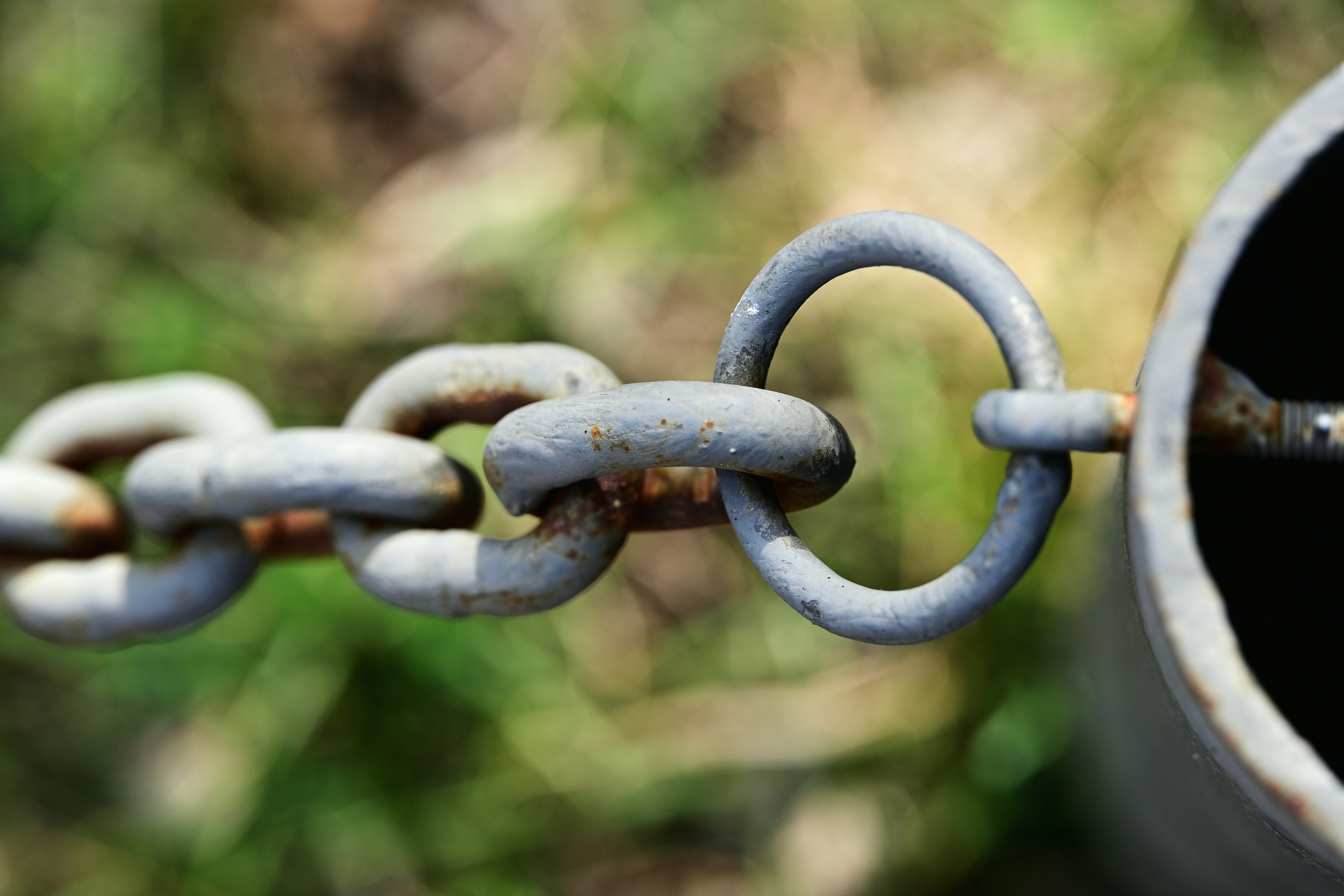 Rusty metal chain fence close up