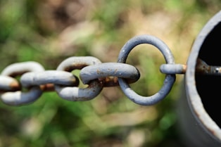 a rusty chain is attached to a pipe