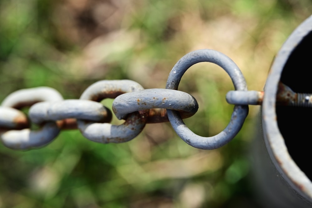 a rusty chain is attached to a pipe