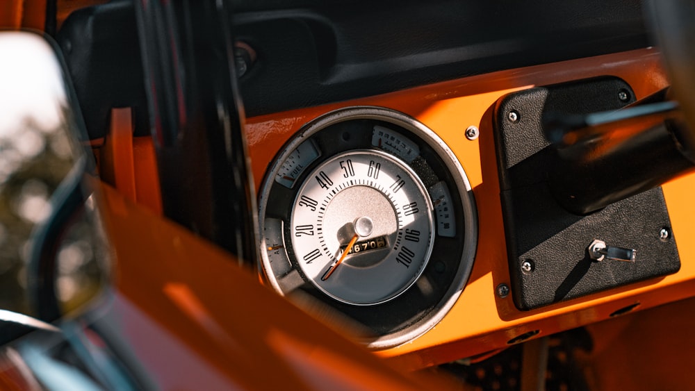 a close up of a clock on a vehicle