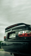a black car parked on the side of a road