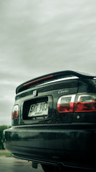 a black car parked on the side of a road