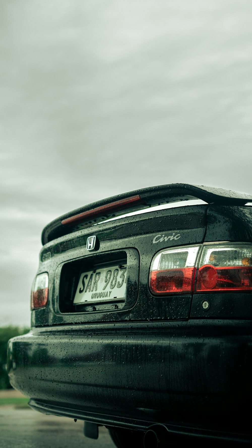 a black car parked on the side of a road