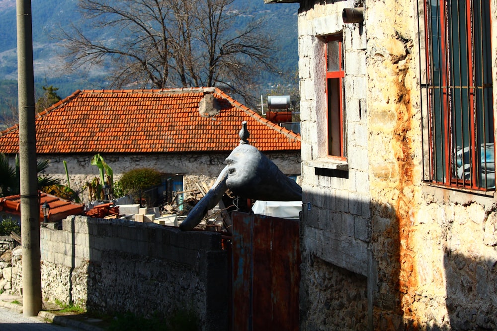 an elephant statue sitting on the side of a building