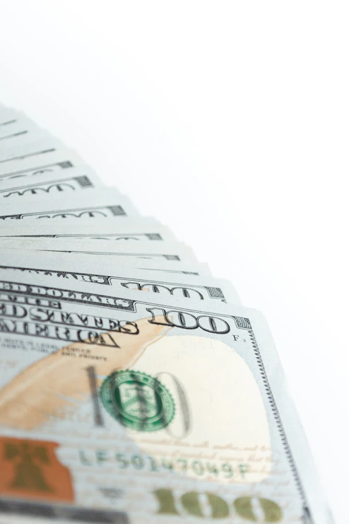 a stack of twenty dollar bills sitting on top of each other