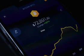 a close up of a cell phone with a bitcoin on it