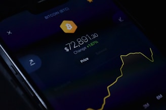 a close up of a cell phone with a bitcoin on it