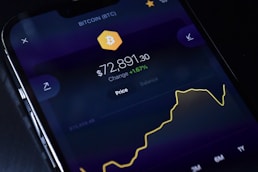 a cell phone displaying bitcoin on the screen