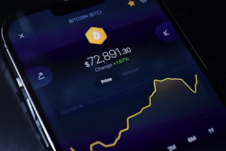a cell phone displaying bitcoin on the screen