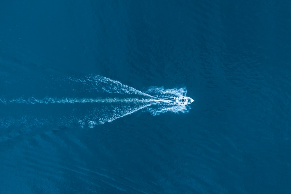 an aerial view of a boat in the ocean