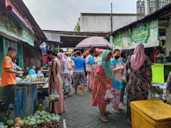 a group of people standing around a market
