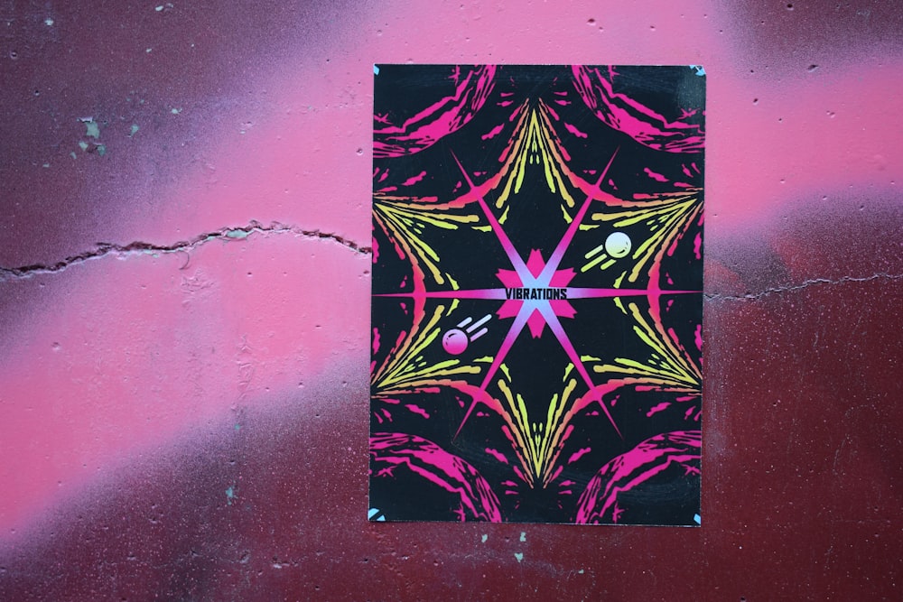 a picture of a pink and black design on a wall